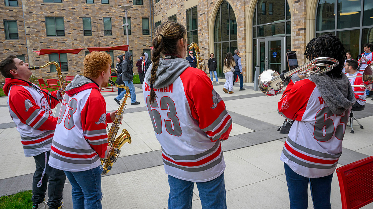 Band members play music for guests at an open house