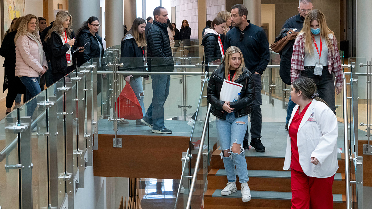 A nursing student leads a group on a tour of the Sacred Heart University Center for Healthcare Education