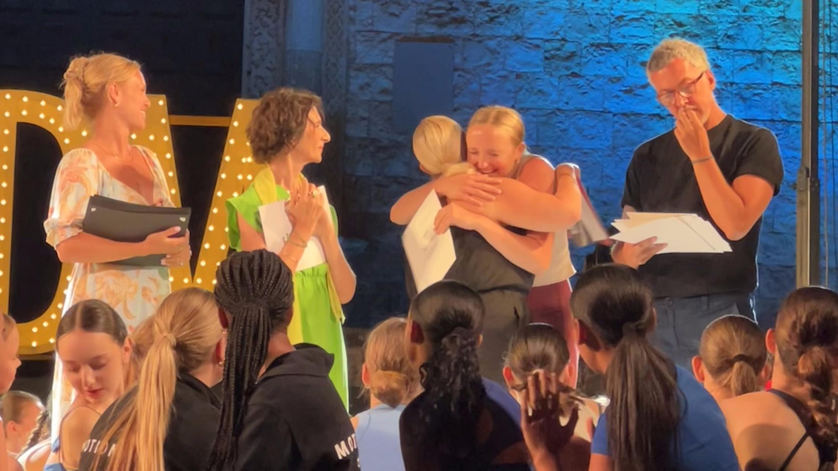 Dancers hugging on stage