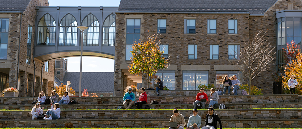 college students sitting on amphitheatre steps