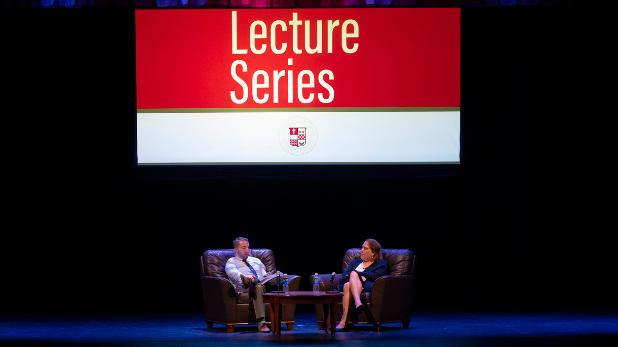 Amy Schneider being interviewed on stage