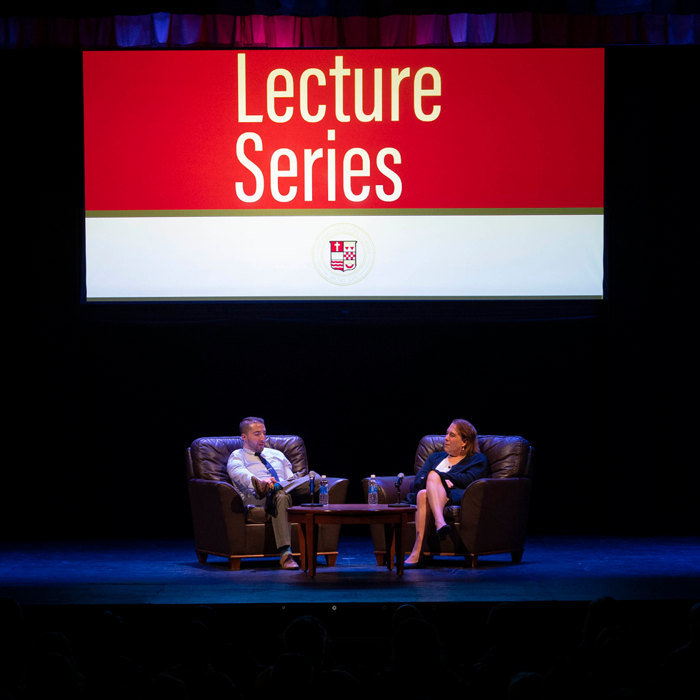 Amy Schneider being interviewed on stage