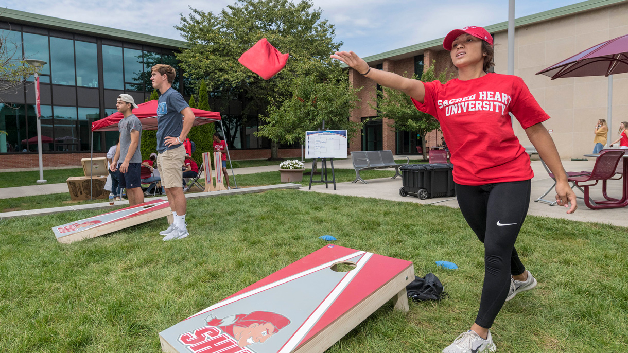Students playing cornhole