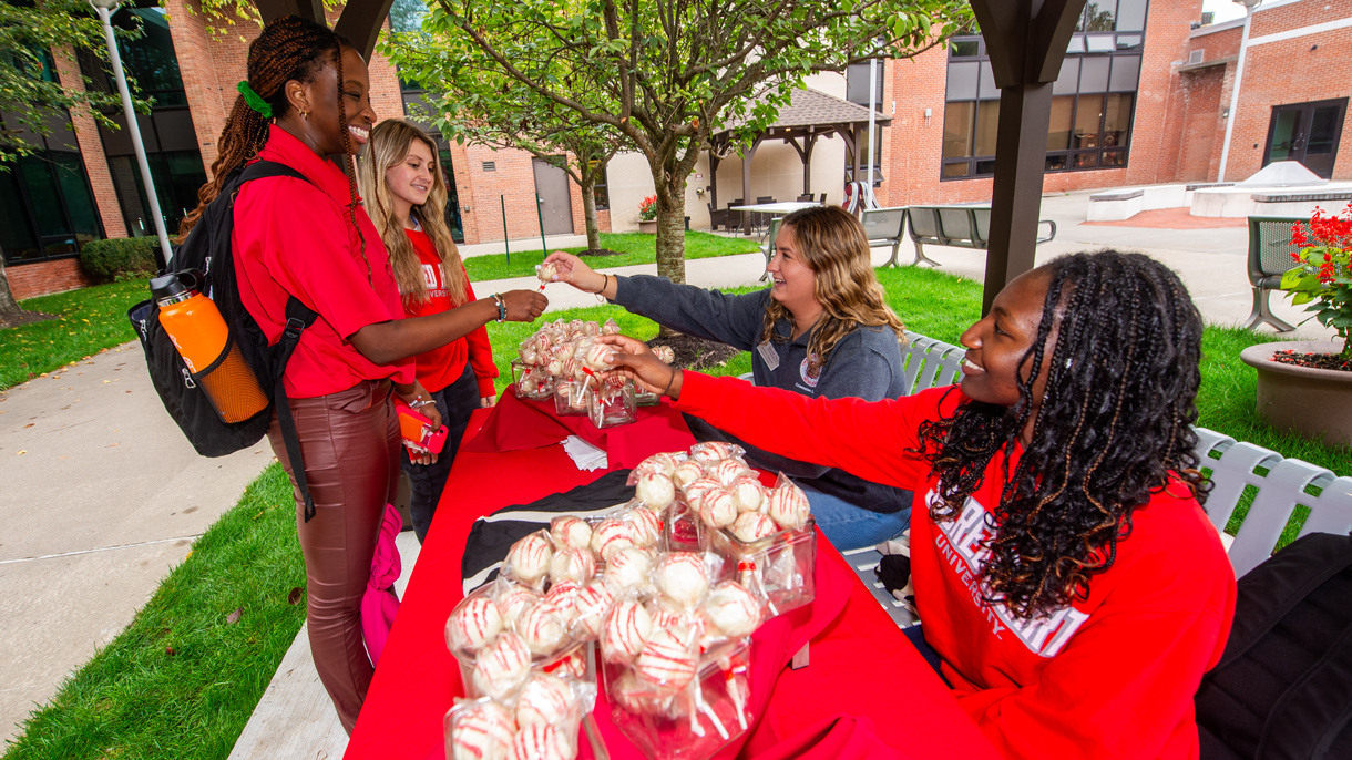 Students being handed cake pops