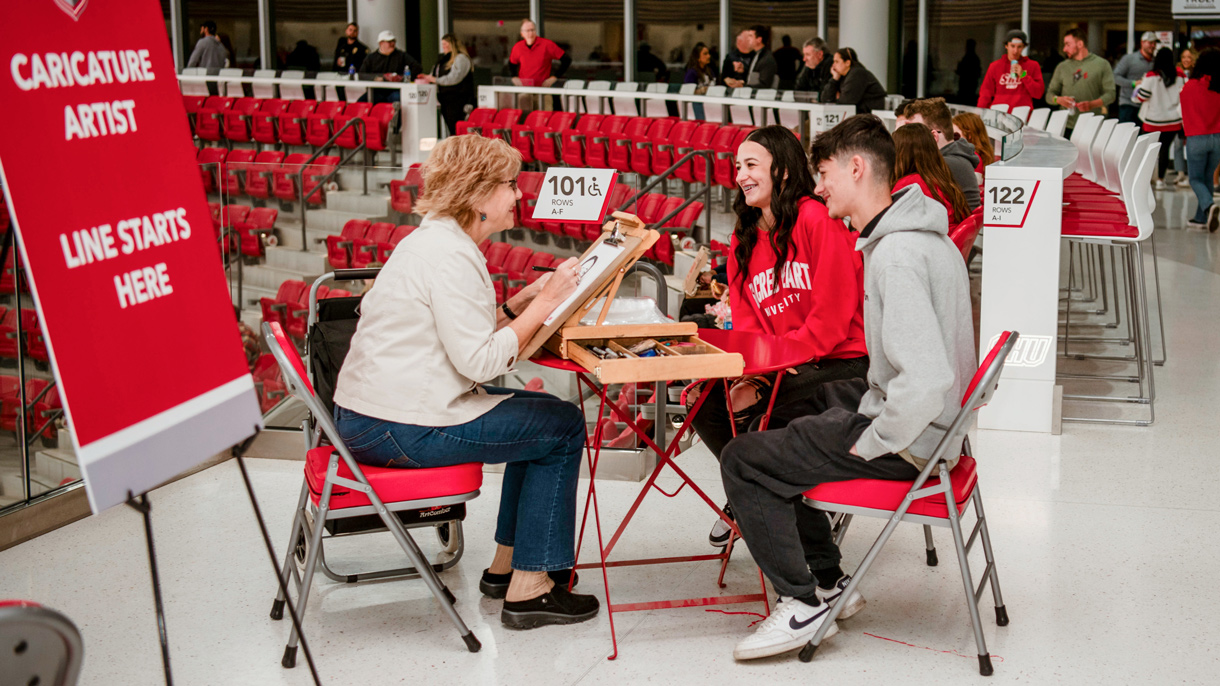 Students getting a caricature drawn