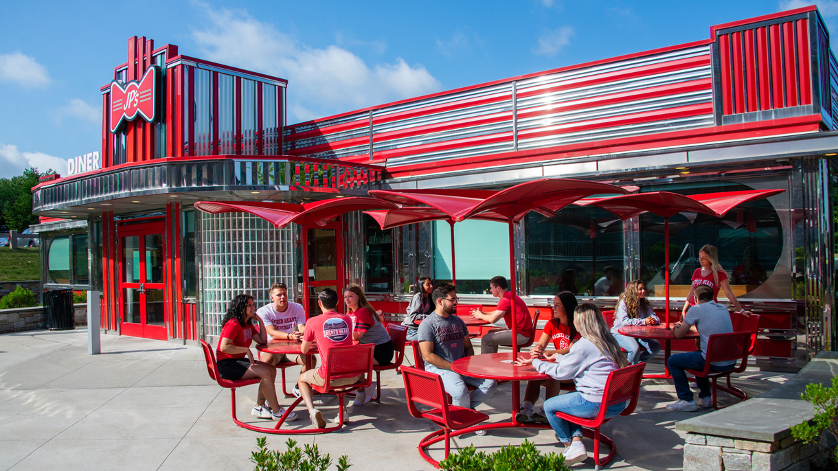 Students sitting outside of JP's Diner