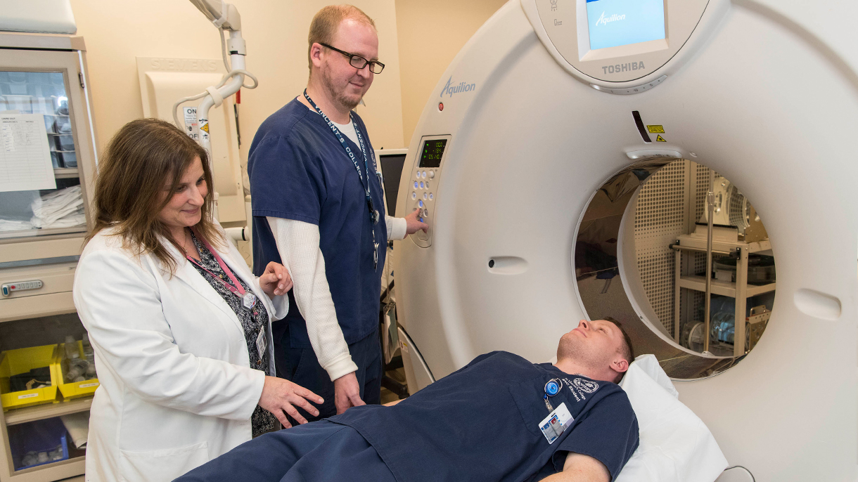 Radiography students and an MRI machine