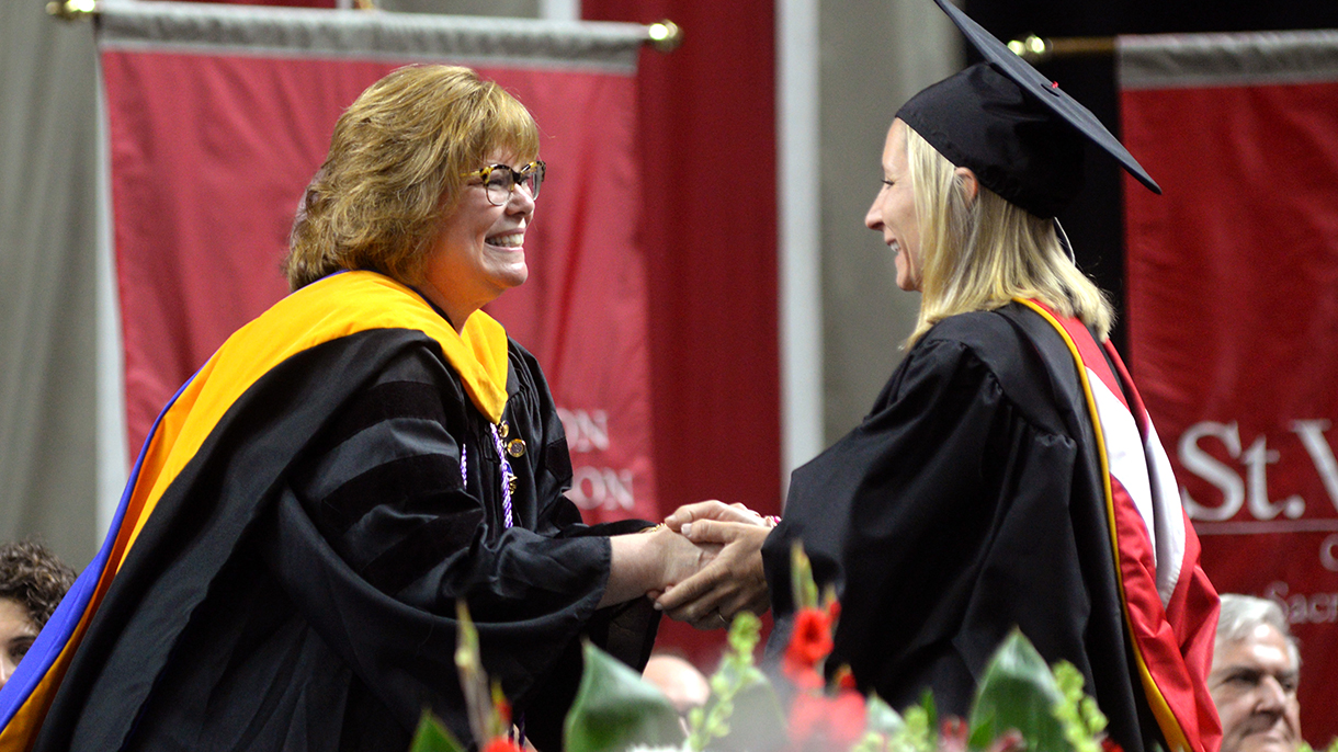 Maryanne Davidson congratulates a graduate