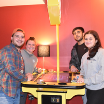 Students in Reds playing arcade game