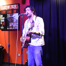 Person singing and playing guitar
