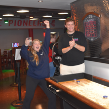 Boy and girl playing shuffleboard