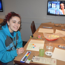 Student painting in Reds