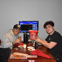 Students in Reds with wing bucket