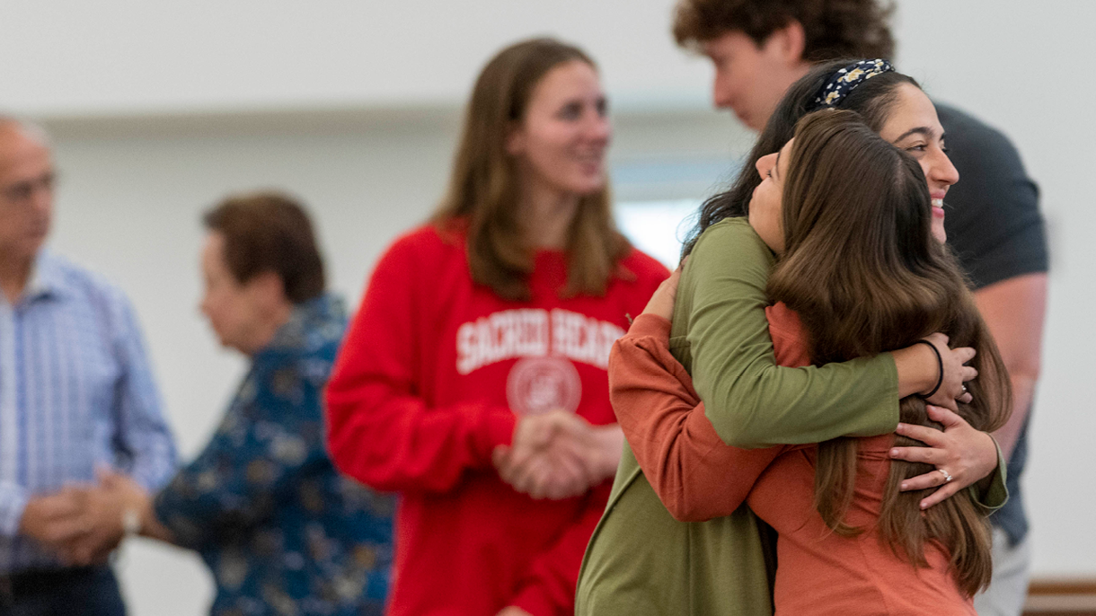 Two girls hugging in the chapel