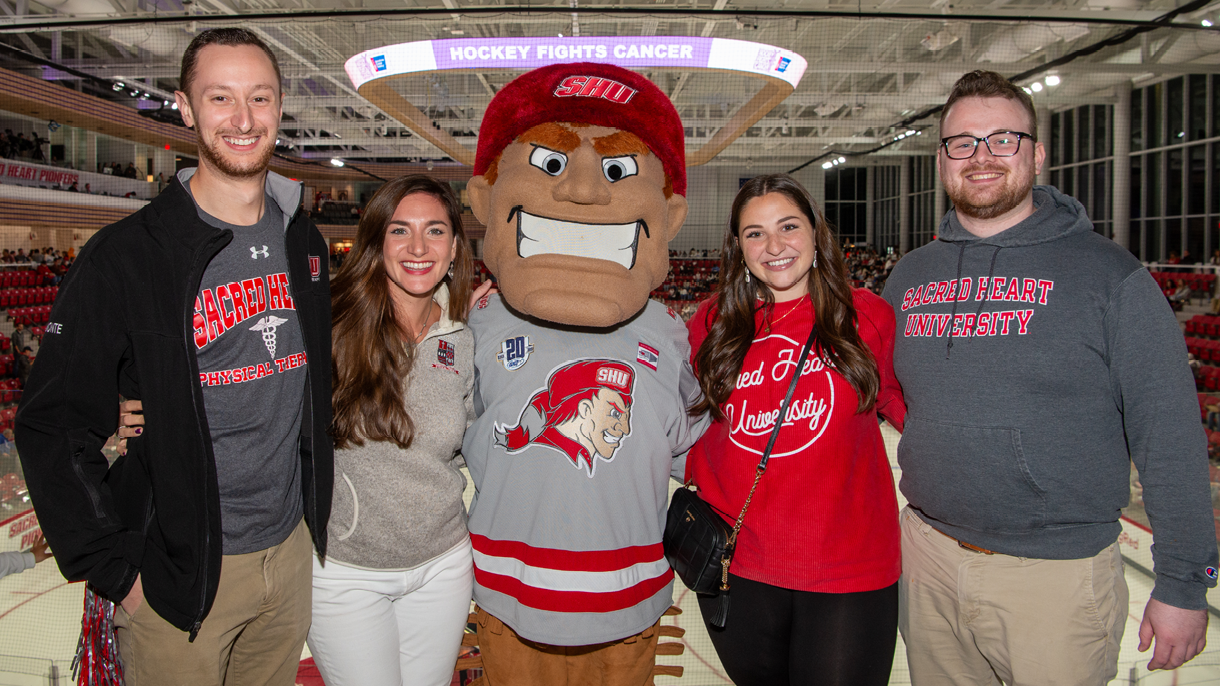 Group with Big Red at hockey game