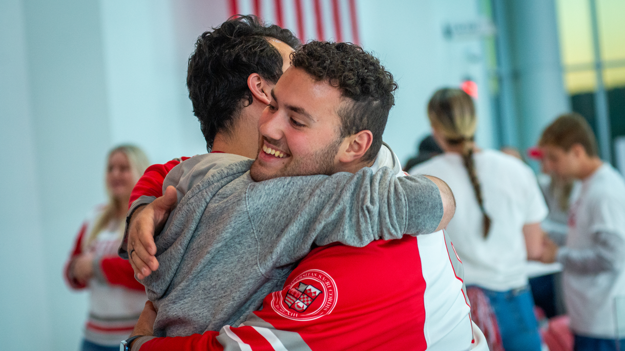 Two students hugging