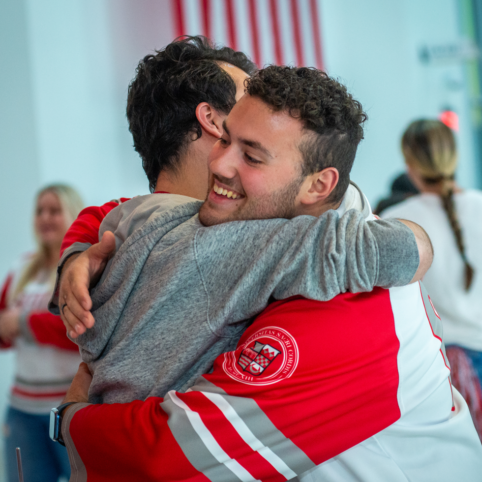 Two students hugging