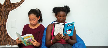Two kids reading books