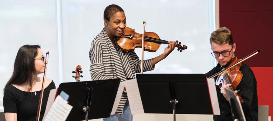 Professor and students playing instruments