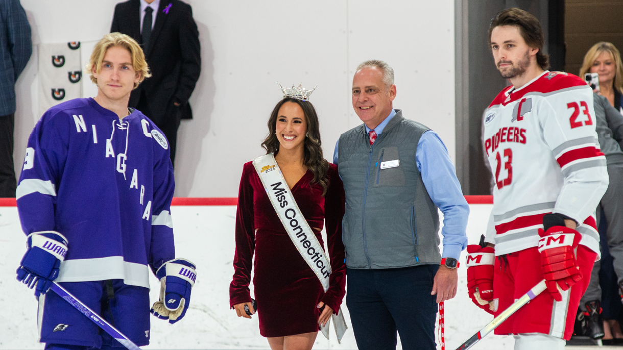 Girl dropping puck for hockey game