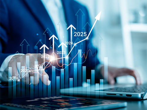 a graph superimposed over a person working on a laptop