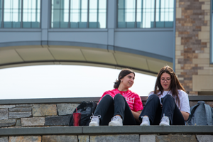 Two students sitting outside talking