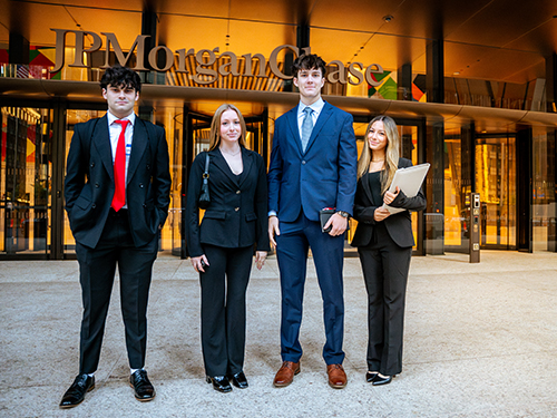 four people in business attire outside of JP Morgan Chase in NYC