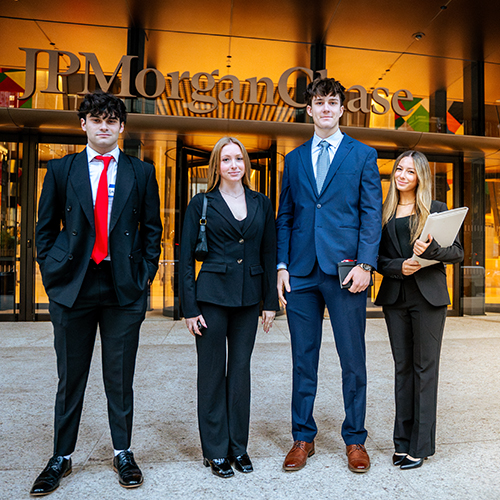 four people in business attire outside of JP Morgan Chase in NYC