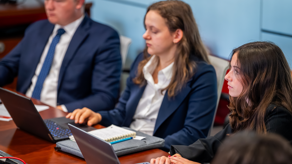 Business professional using laptops during meeting