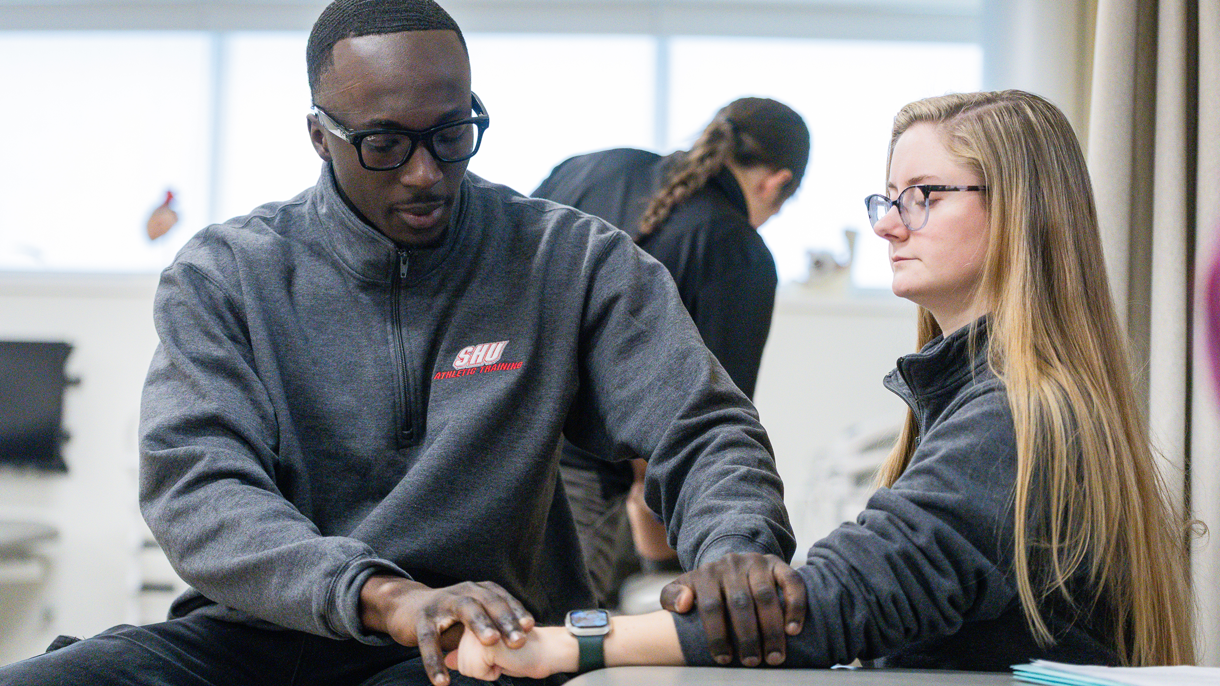 Athletic training students assessing an injury