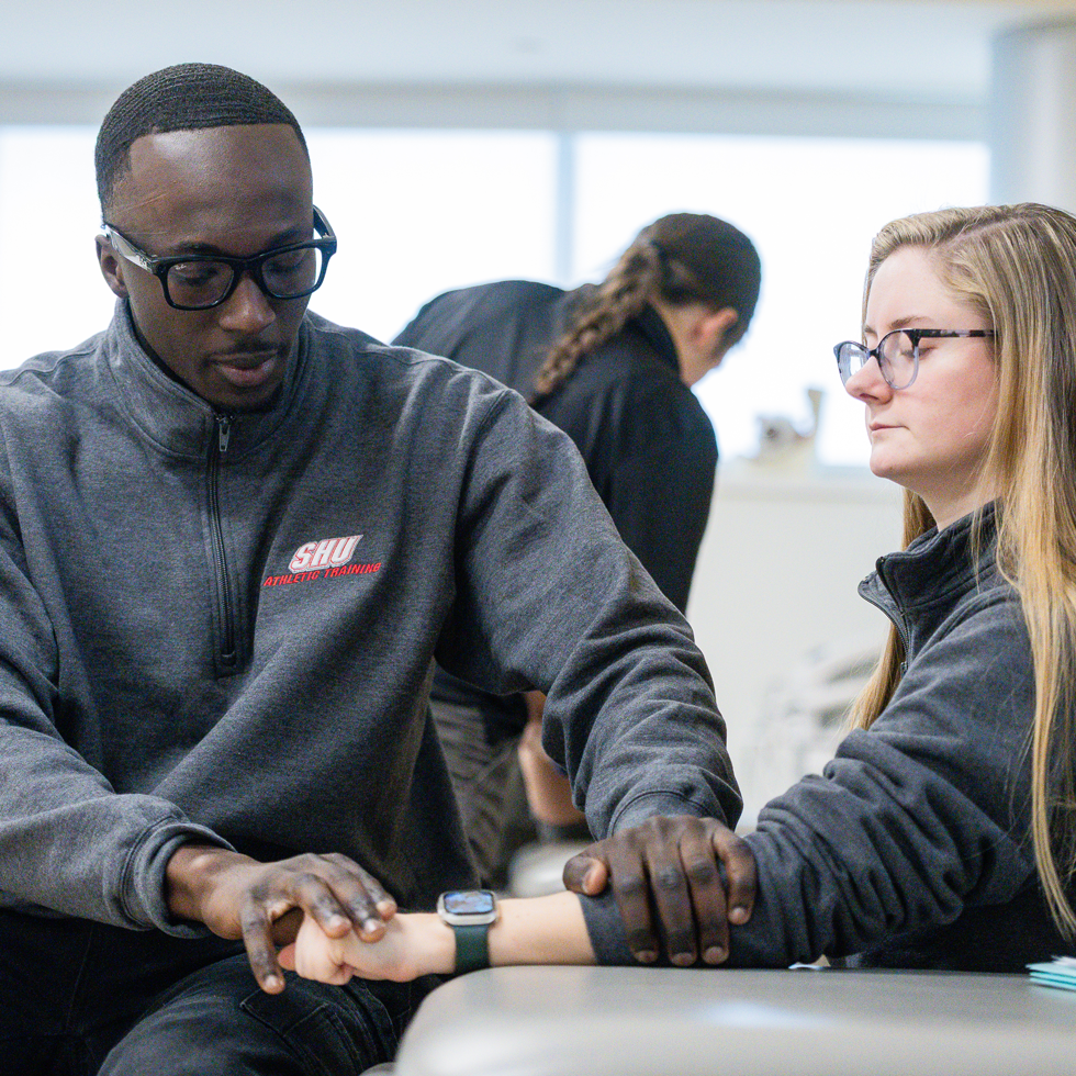 Athletic training students assessing an injury