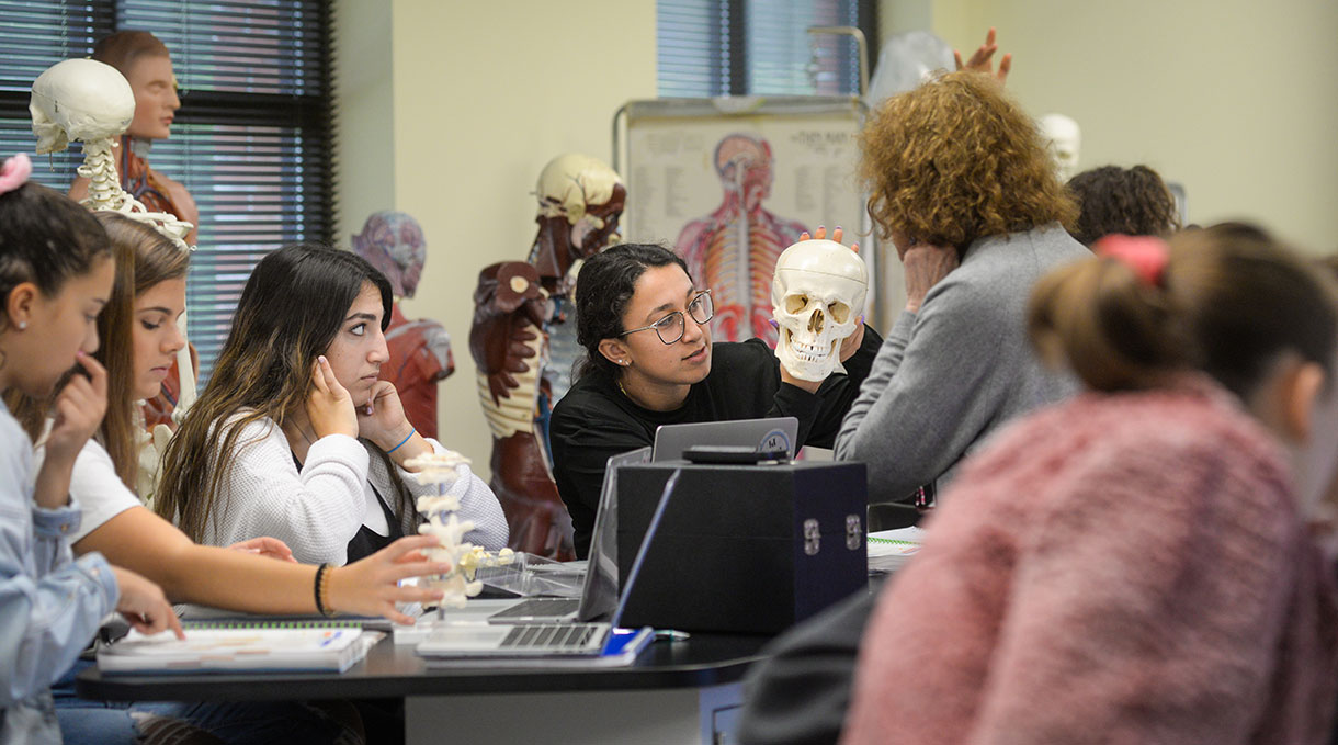 Student holding a skull