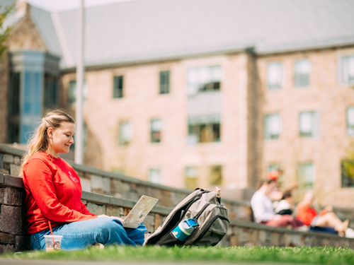 Student sitting outside on laptop