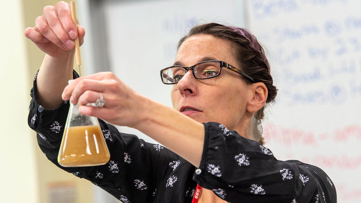 a professor holding a beaker