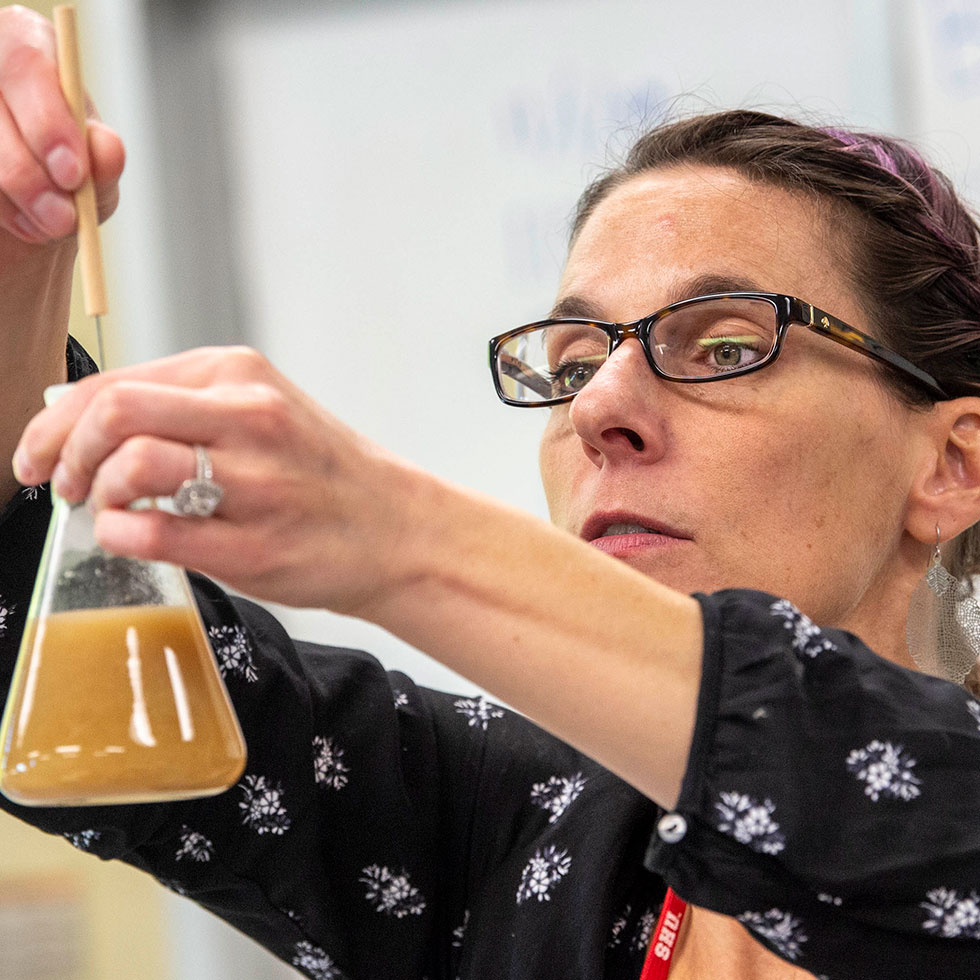 a professor holding a beaker