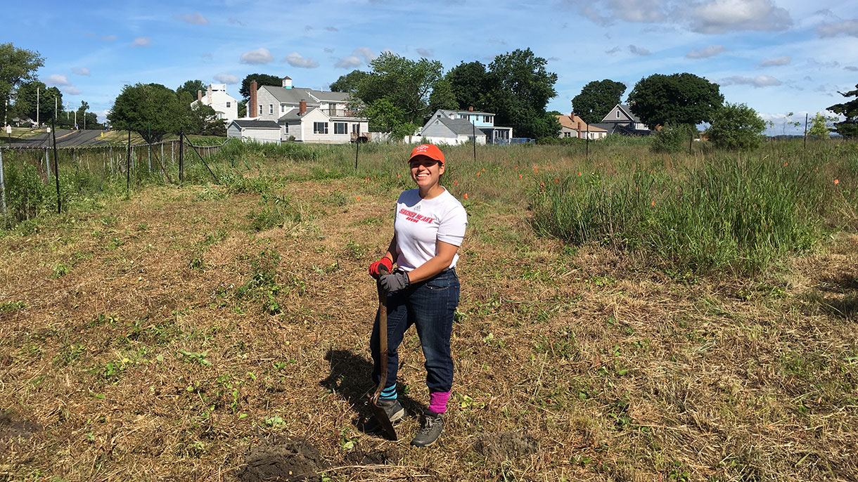 student holding a shovel
