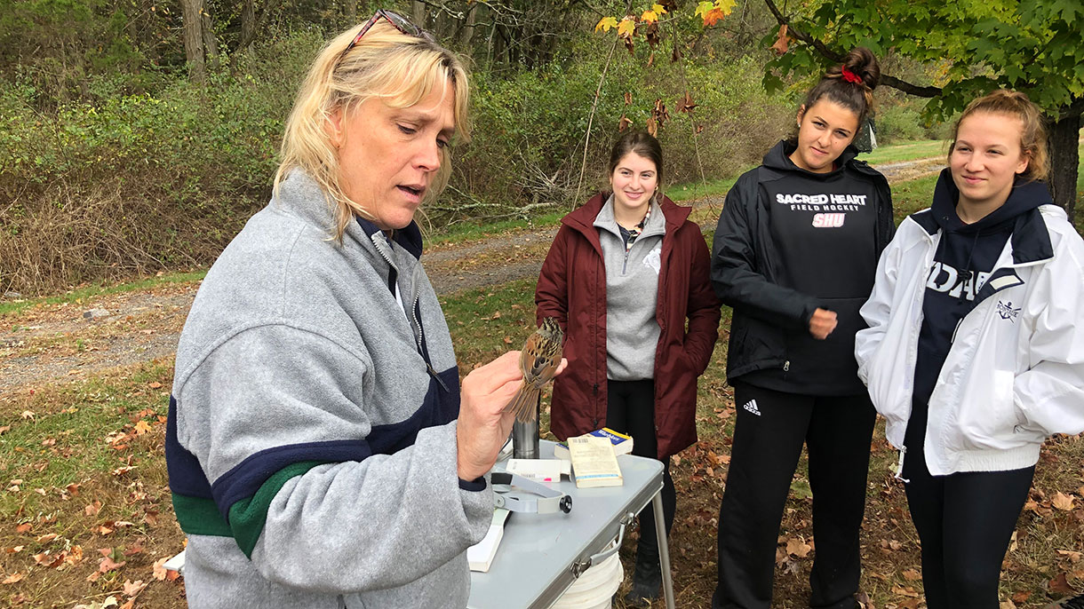 a professor with students outside