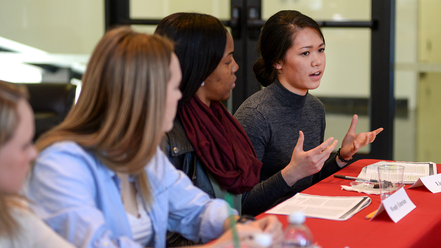 a person gesturing during a class discussion