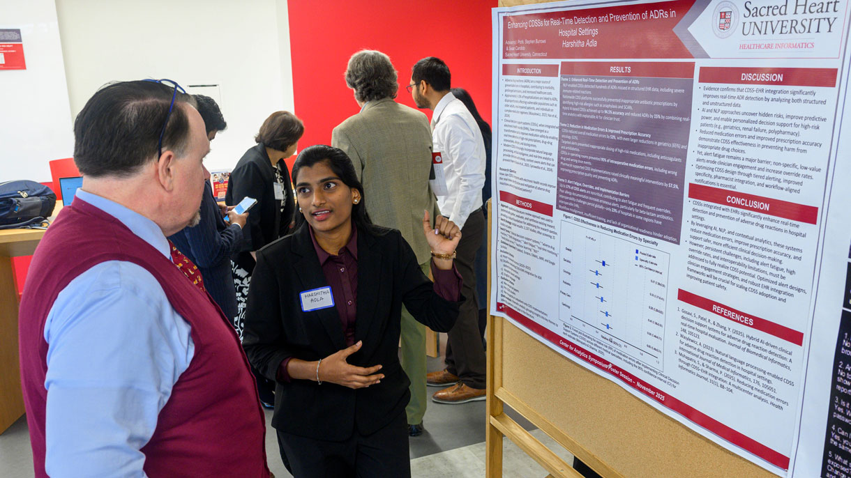 Student explaining research poster to someone
