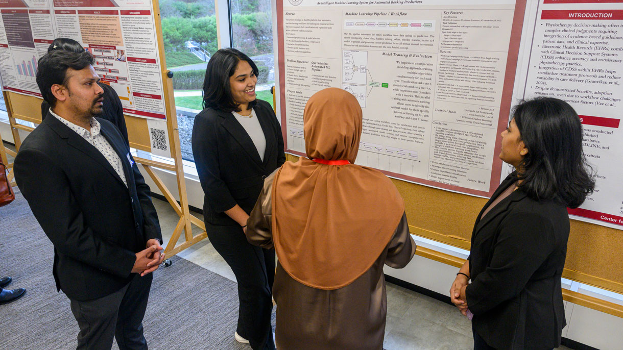 Students talking about research poster