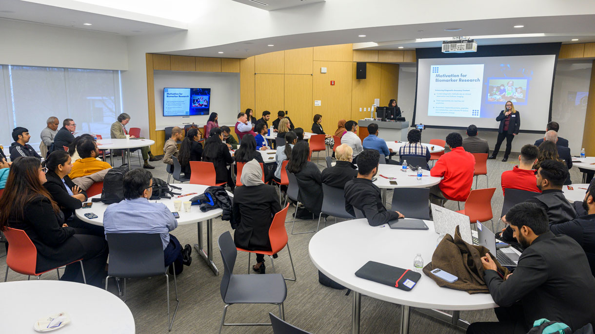 Someone presenting to a room full of people