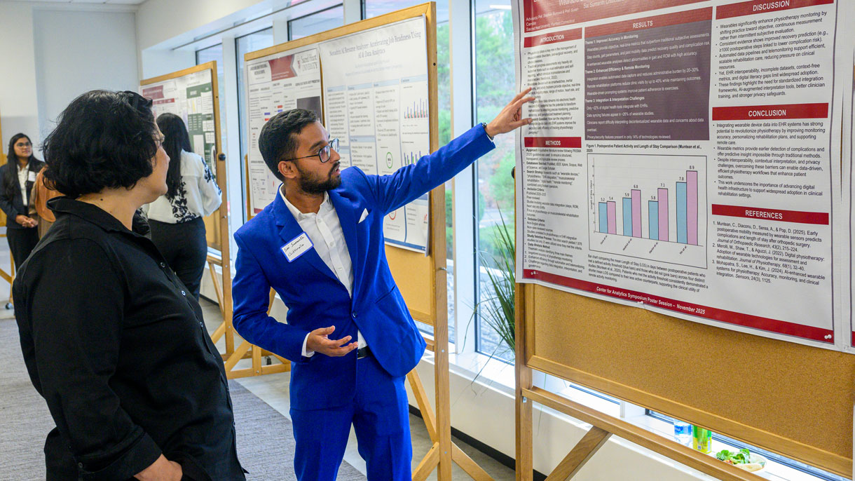 Student explaining research poster to someone