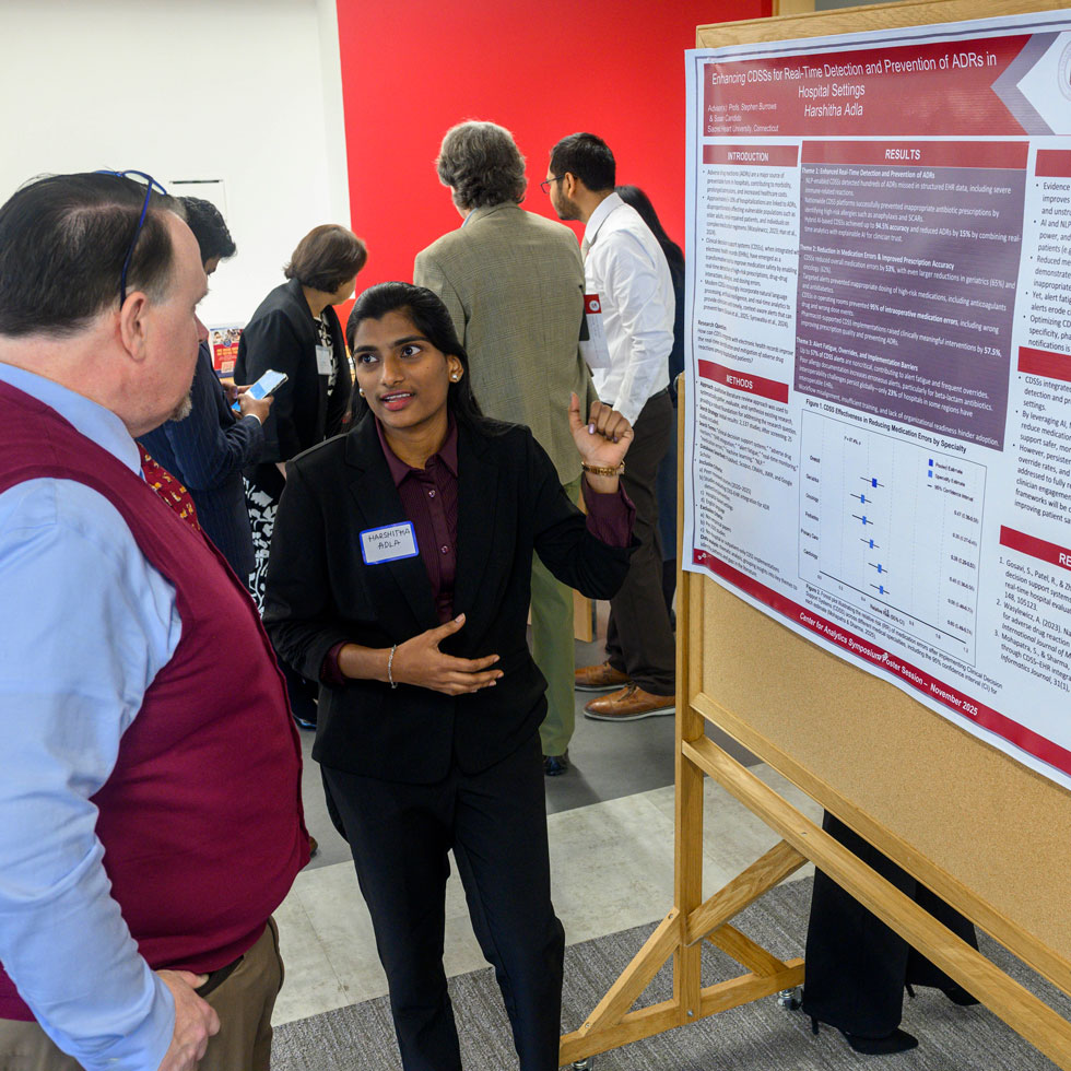 Student explaining research poster to someone