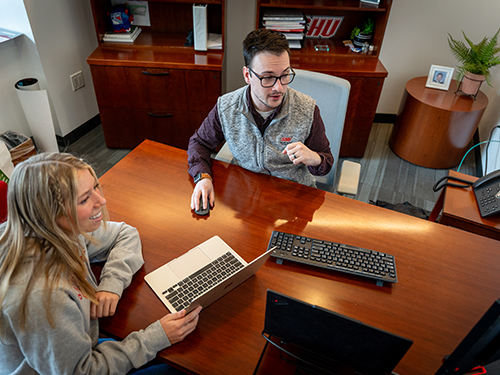 A career counselor meeting with an undergraduate student in an office