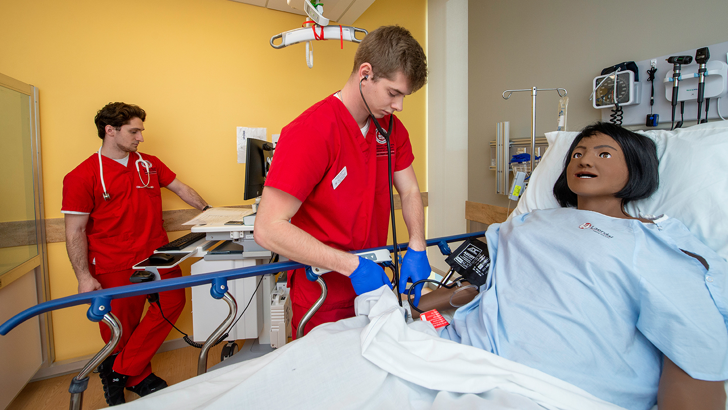 student nurse administering care in a clinical setting