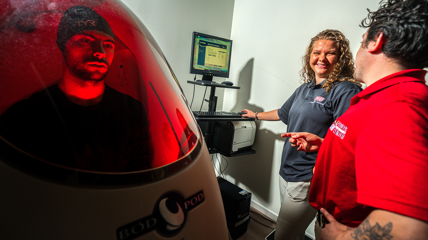 someone sitting in a Bod Pod that using Air Displacement Plethysmography to measure body composition