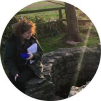 Marie Hulme sitting next to a well