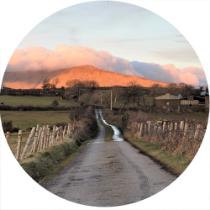 Ireland landscape showing windy road against a sunset