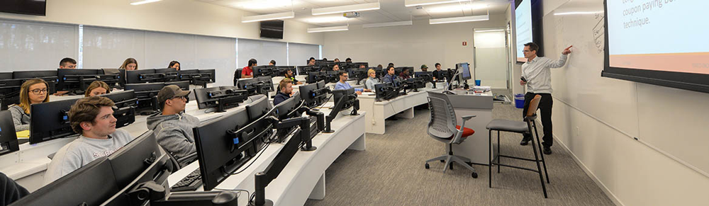 Professor talking to students in classroom