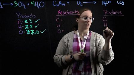 Professor Emily Mane lecturing on Chemistry formulas using the Lightboard